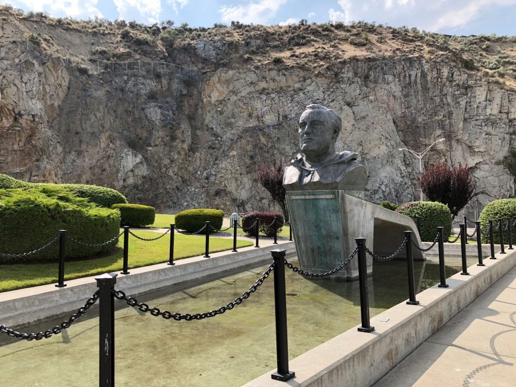 FDR monument at Grand Coulee Dam facing the granite cliffs.