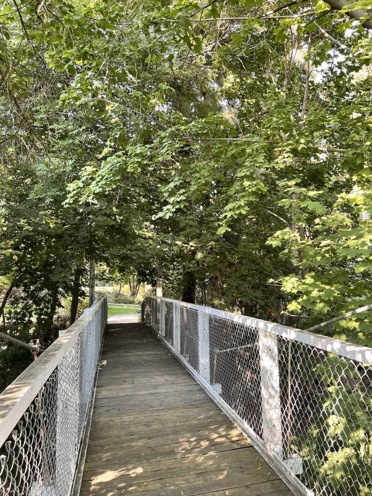 white wooden bridge over Fiddle Creek to Cole Park